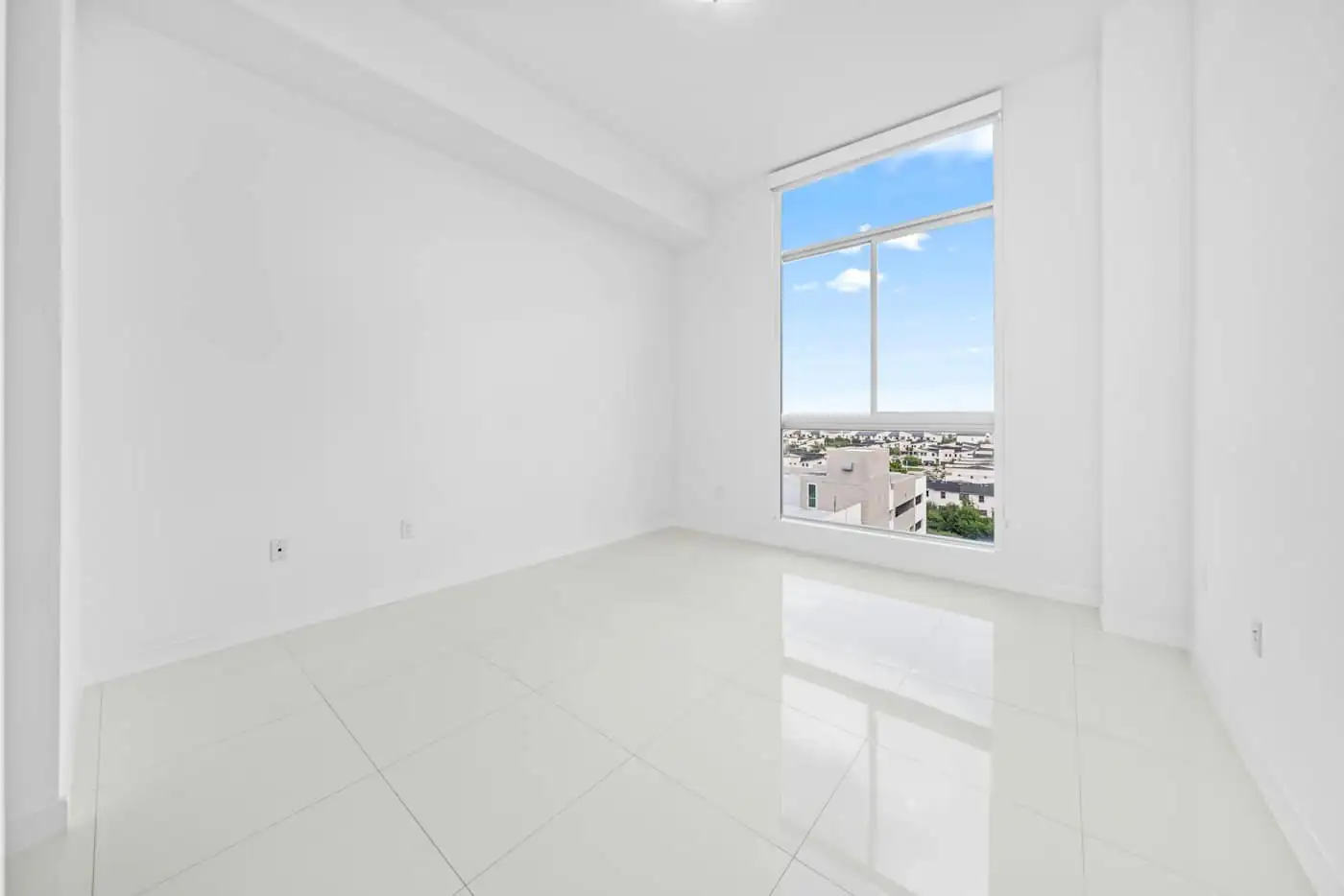 Interior of a nearly finished house with floor tiles laid and walls freshly painted